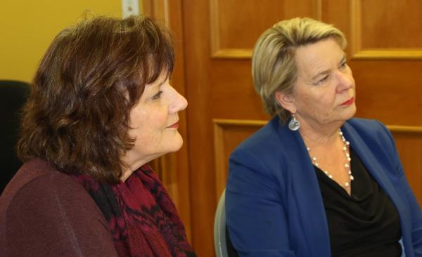 Gerri and Minister Wagner listen intently at the workshop